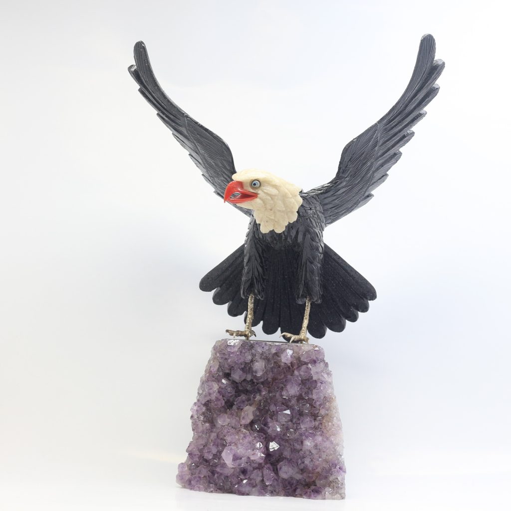Aigle en onyx et quartz blanc sur druse d’améthyste sculpée